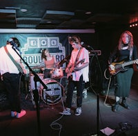 a group of people playing music in a room